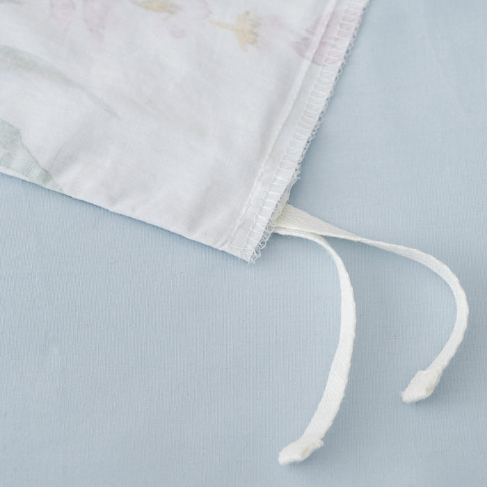 Close-up of the Seraphine Blooms Duvet Cover Set ties showcasing soft cotton fabric and floral design details.