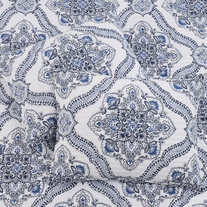 Lentana Navy Quilt Set featuring an intricate medallion pattern in navy on a soft white ground.