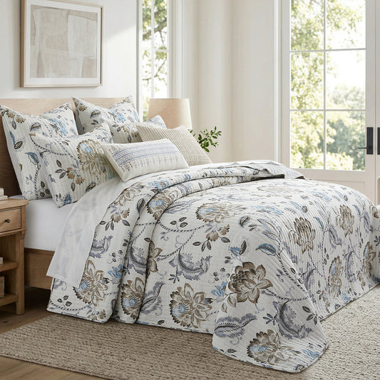 Floral patterned bedding set on a bed in a bright bedroom