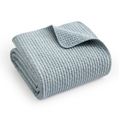 Pick-Stitch Artisan Quilted Throw in soft blue color, showcasing its textured quilted surface and pick-stitch detailing.