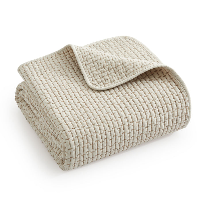 Pick-Stitch Artisan Quilted Throw in a soft beige hue, showcasing pick-stitch detailing and a cozy folded design.