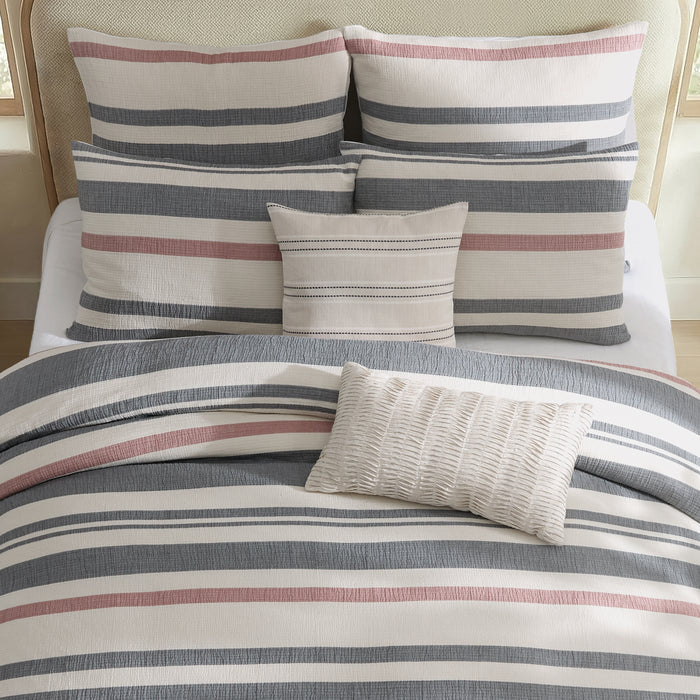 Striped bedding set with pillows on a bed
