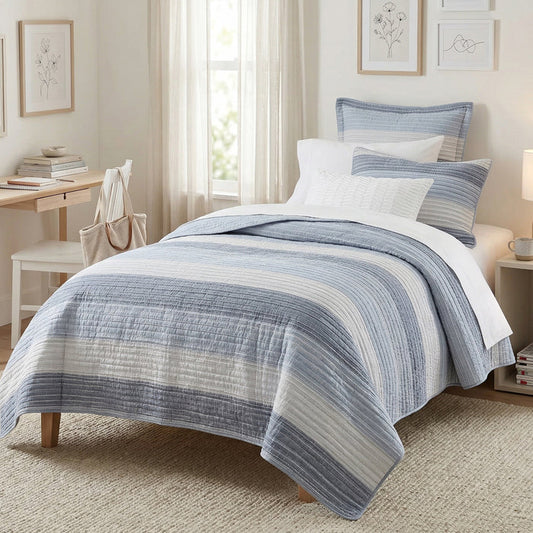 Bedroom with a bed covered in blue and white striped bedding
