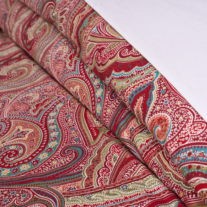 Spruce Comforter Set featuring vibrant paisley print in red and gold, showcasing rich colors and intricate patterns.